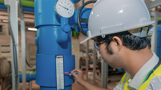 Workers are inspecting transmitters that utilize IoT systems